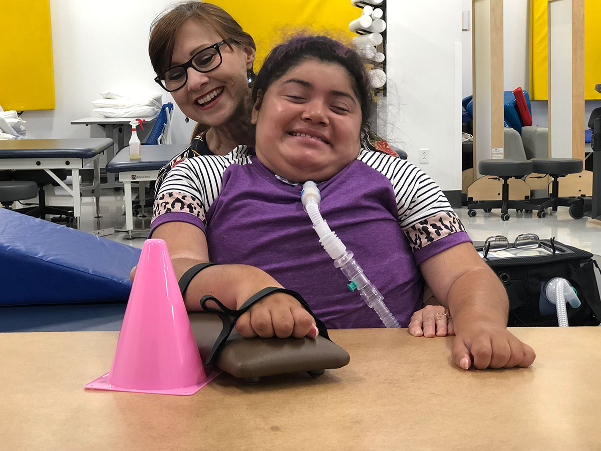 Dr. Selina Morgan works with a pediatric patient in a physical therapy session