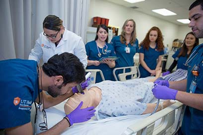 School of Health Professions instructing students in simulated patient care