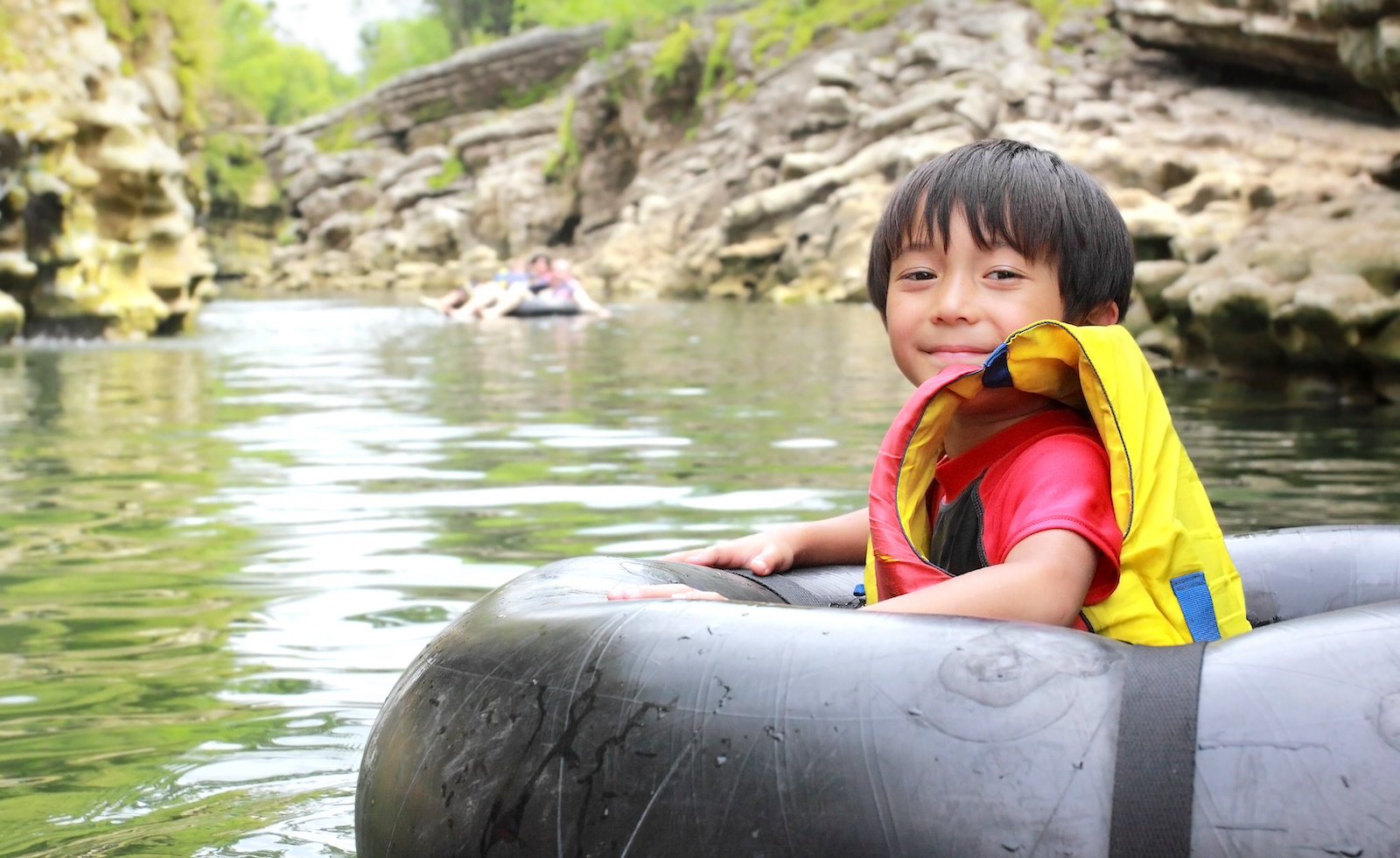 River tubing with child smiling