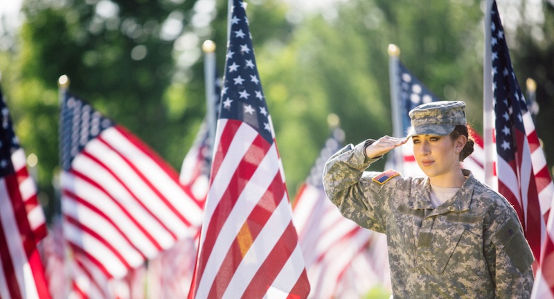 Military female saluting the flag