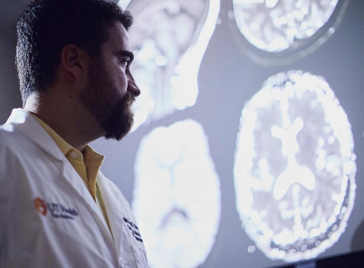 Doctor looking at brain scans in a dark room