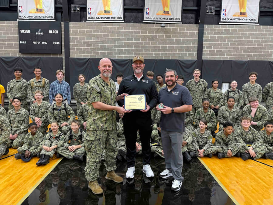 Sea cadets gather behind program leaders for a group photo.