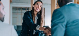 woman shaking hands with man