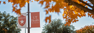 Fall foliage with UT Health San Antonio banners in the background